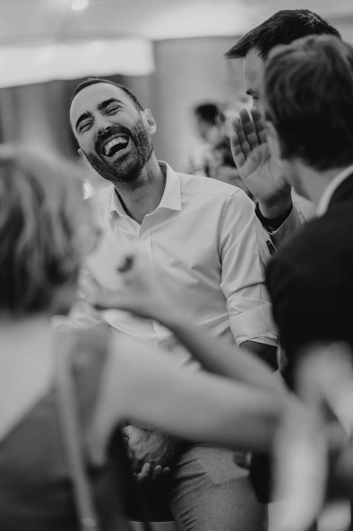 man laughing hard during wedding reception