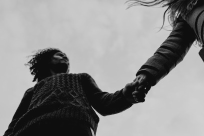 couple holding hands photographed from below