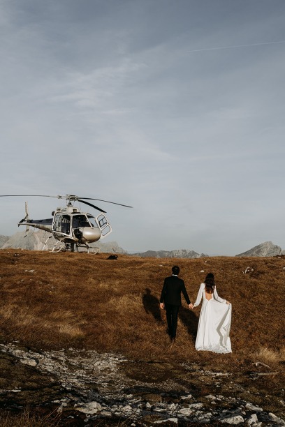 married couple walking towards helicopter