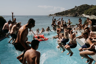 weddings guests jumping in swimming pool