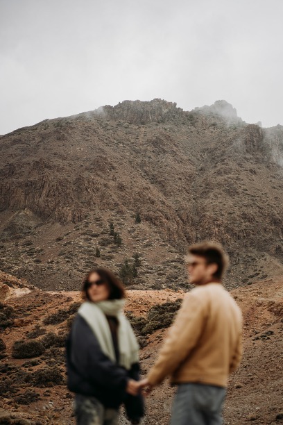 out of focus couple in volcanic cloudy landscape