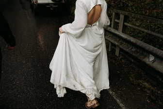 bride holding dirty wedding dress