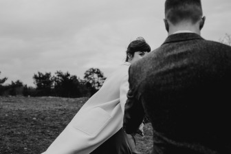 bride looking behind her shoulder at groom